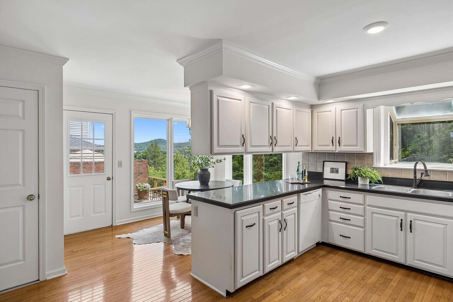 After ListKit editing, the same kitchen listing photo with balanced color and clear window detail