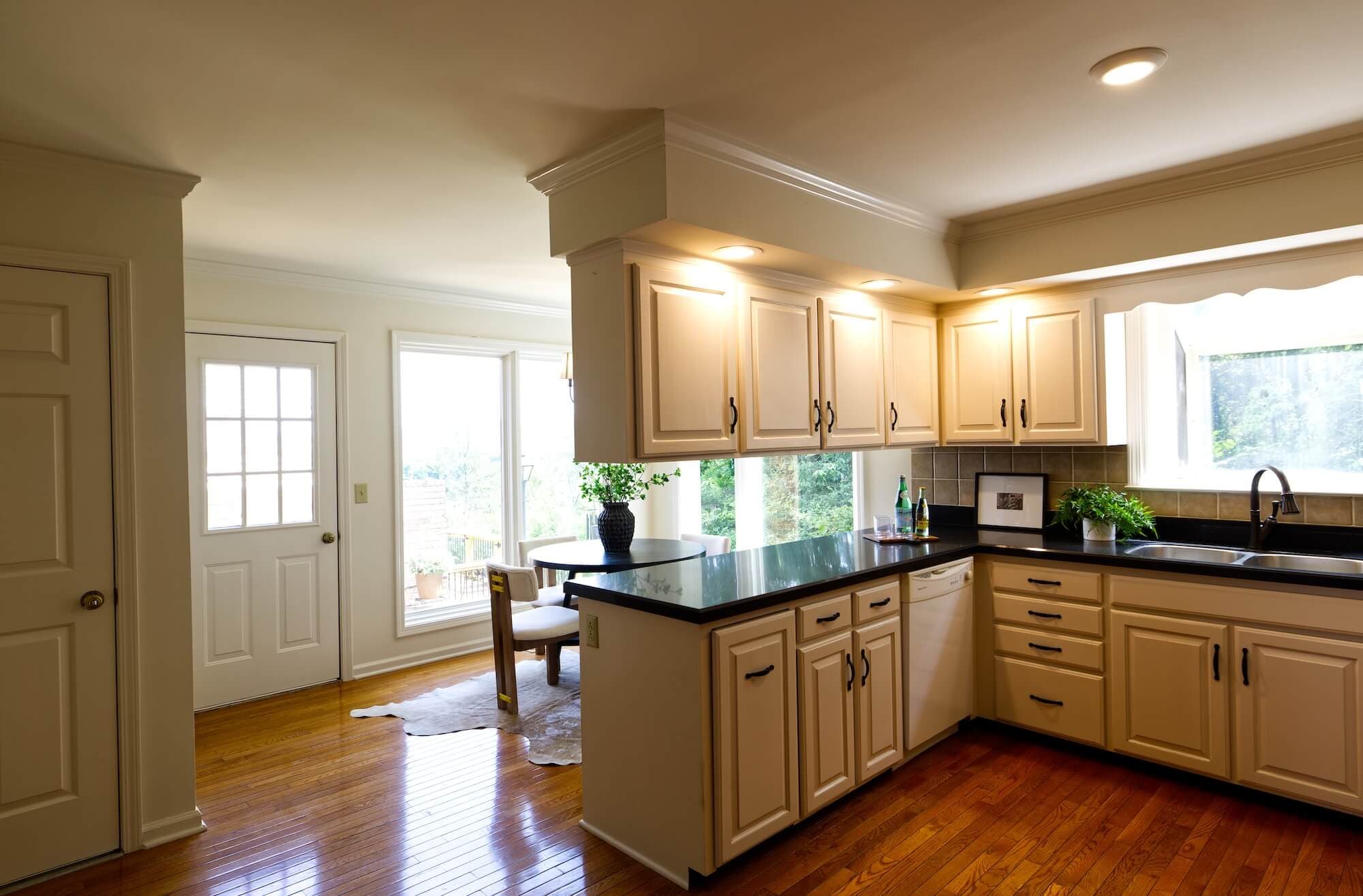 Before ListKit editing, a kitchen listing photo with warm lighting and blown-out windows